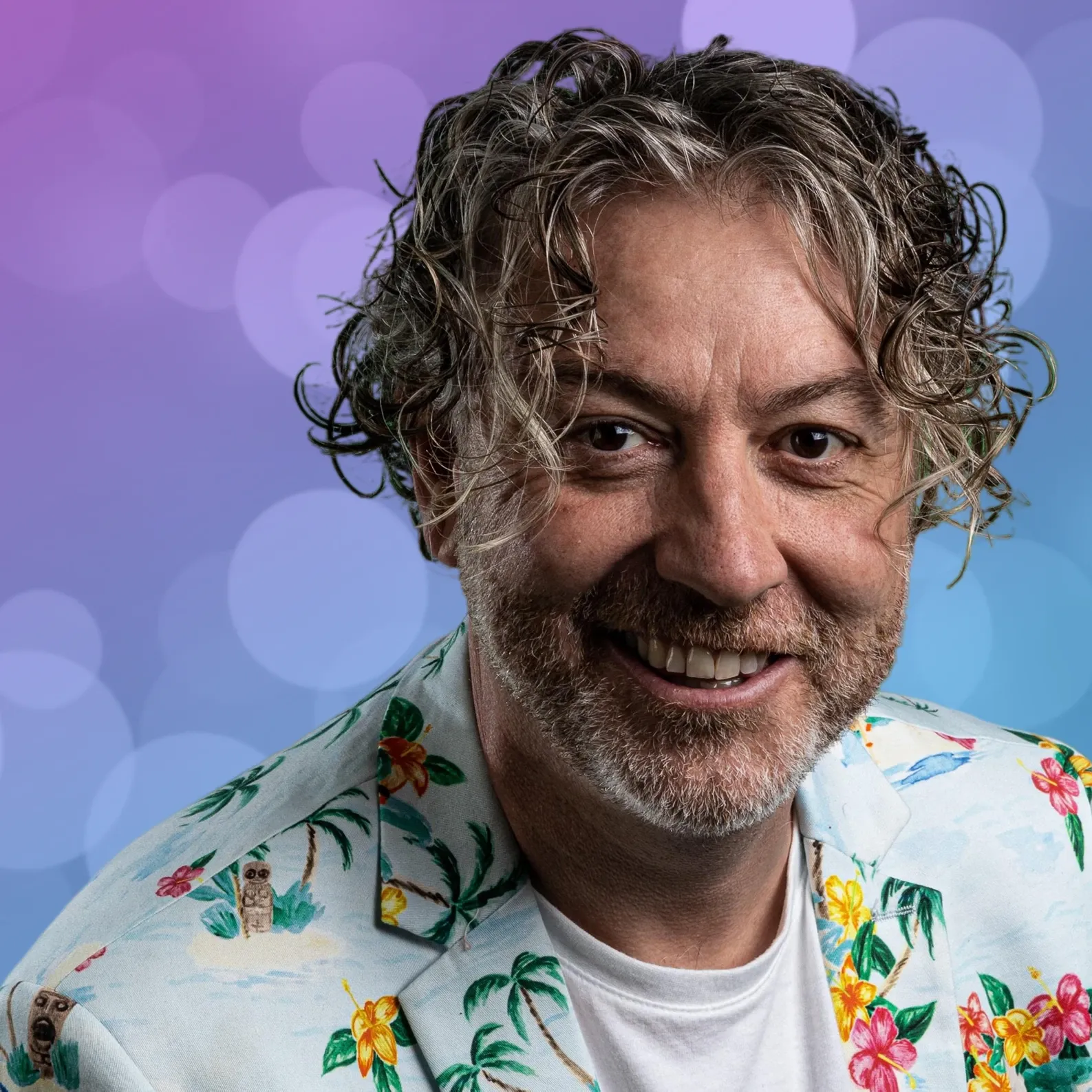 Paul, smiling, in a floral shirt